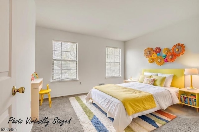 carpeted bedroom featuring multiple windows