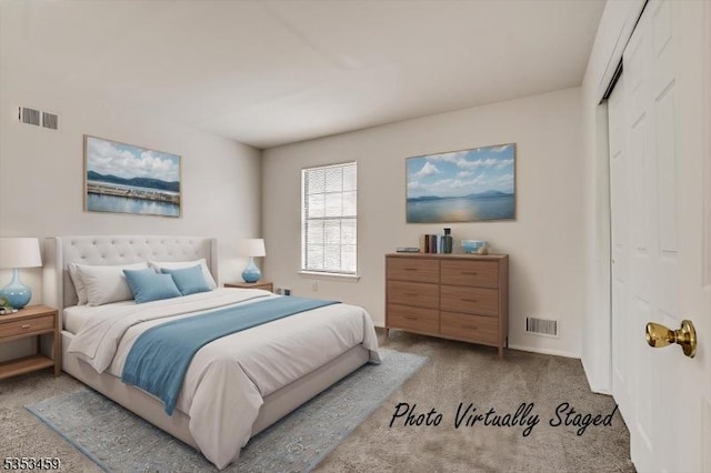 carpeted bedroom featuring visible vents and a closet