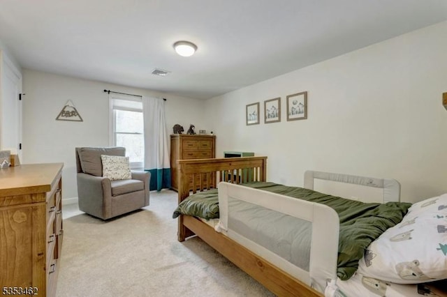 bedroom featuring light colored carpet and visible vents