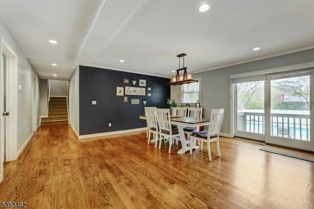 dining space with baseboards, ornamental molding, wood finished floors, and recessed lighting
