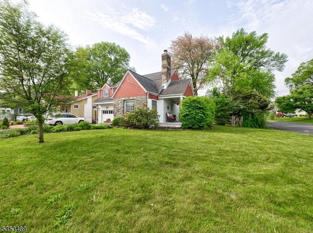view of front of house with a front lawn, a chimney, and stone siding
