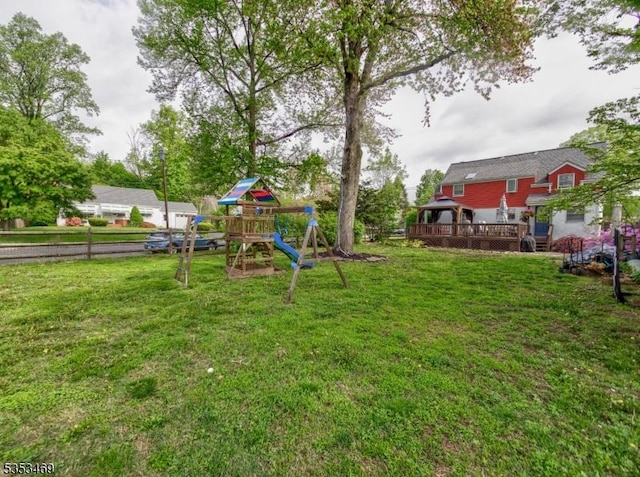 view of yard featuring a playground, a gazebo, and a wooden deck