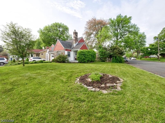 exterior space with a front lawn and a chimney