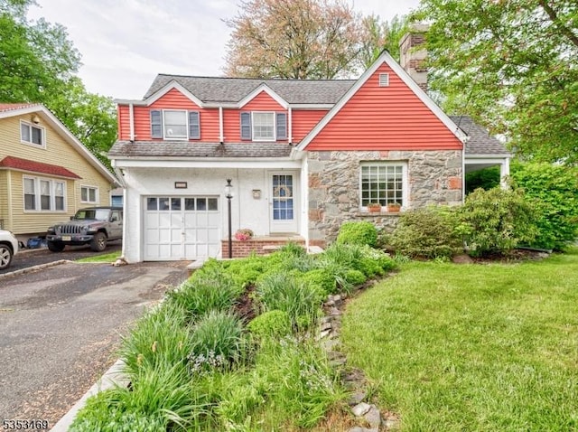 traditional home featuring an attached garage, driveway, stucco siding, a front lawn, and a chimney