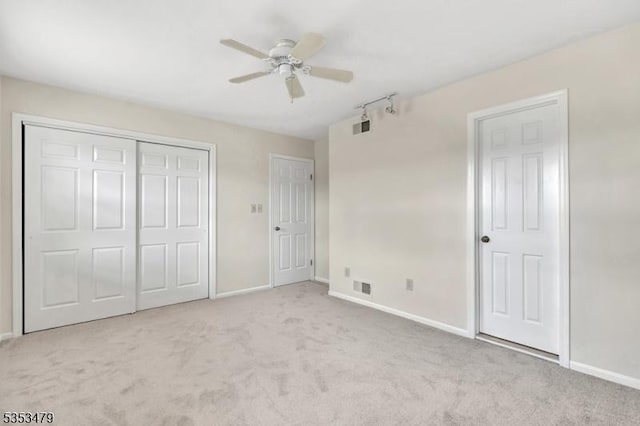 unfurnished bedroom featuring visible vents, baseboards, and carpet floors
