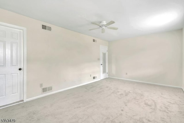 spare room featuring visible vents, a ceiling fan, and baseboards
