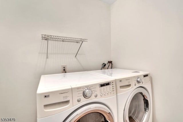 washroom with separate washer and dryer and laundry area