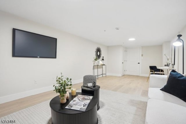 living room with baseboards, recessed lighting, and wood finished floors
