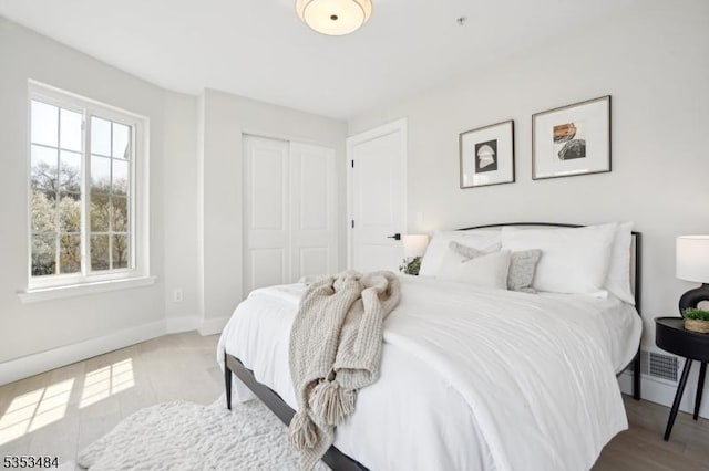 bedroom with a closet and baseboards