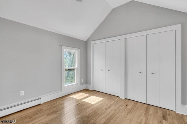 97 Belvidere Ave, Oxford Twp, NJ 07863 - unfurnished bedroom with baseboard heating, wood finished floors, multiple closets, and vaulted ceiling