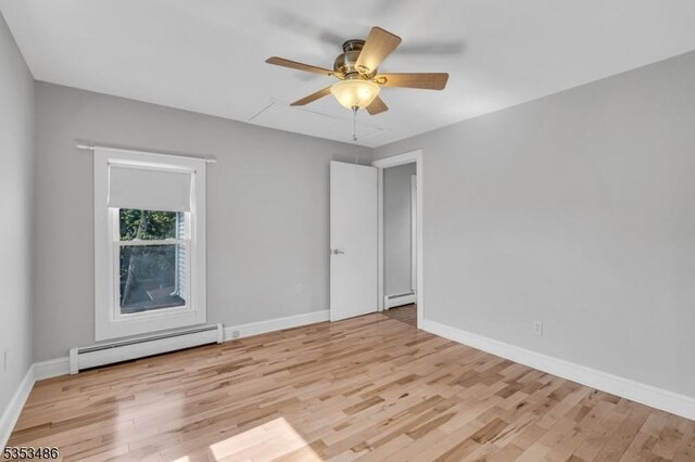 97 Belvidere Ave, Oxford Twp, NJ 07863 - unfurnished room with baseboards, ceiling fan, light wood-style flooring, and a baseboard radiator
