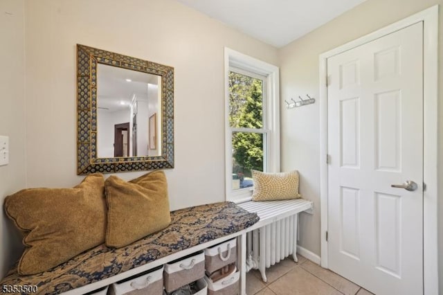 mudroom with baseboards and light tile patterned floors