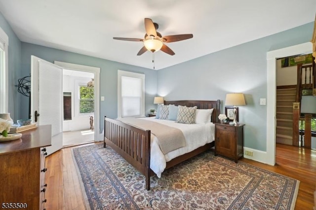 bedroom with baseboards, a ceiling fan, and wood finished floors