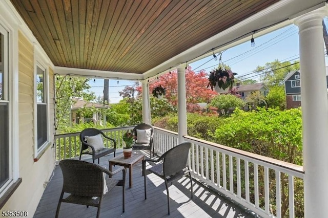 wooden deck featuring a porch and outdoor lounge area