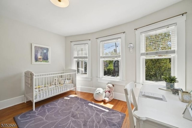 bedroom featuring baseboards and wood finished floors