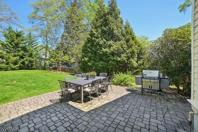 view of patio with outdoor dining area and grilling area