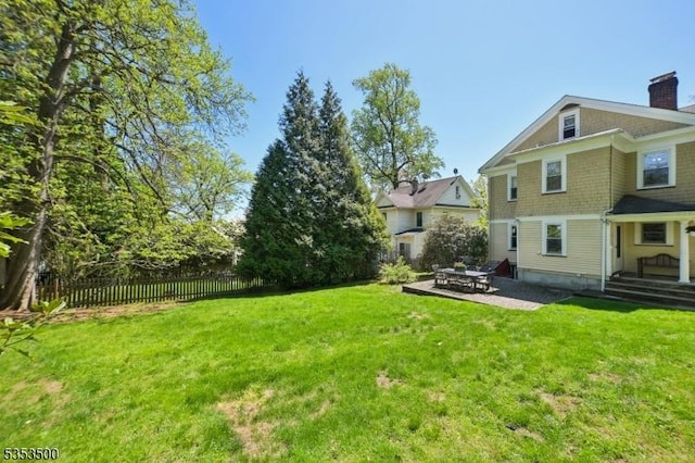 view of yard featuring fence and a patio area