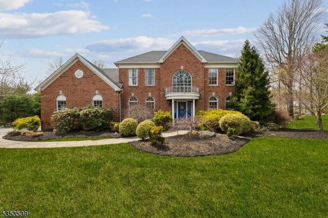 colonial house with brick siding and a front lawn