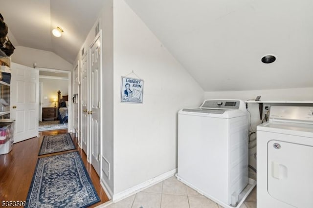 washroom with washer and dryer and light wood-type flooring