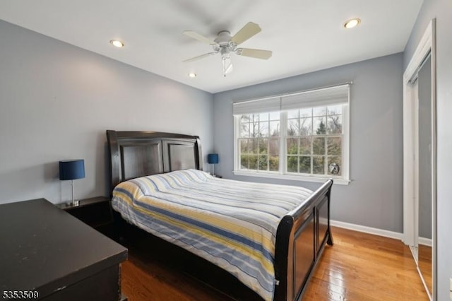 bedroom with baseboards, recessed lighting, wood finished floors, and a ceiling fan