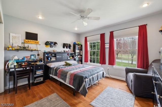 bedroom featuring wood finished floors, ceiling fan, recessed lighting, and baseboards