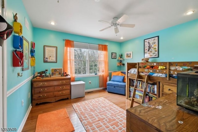 bedroom with wood finished floors, recessed lighting, and baseboards