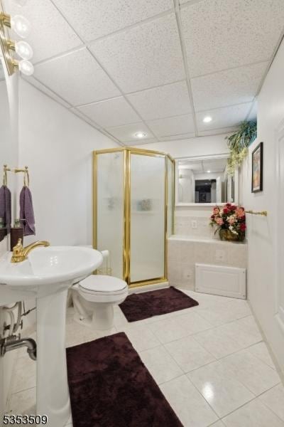 full bathroom with recessed lighting, tile patterned flooring, a drop ceiling, a shower stall, and toilet