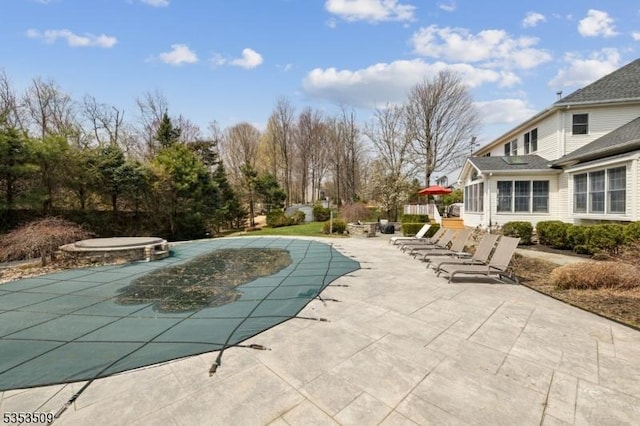 view of pool with a covered pool, a hot tub, and a patio area