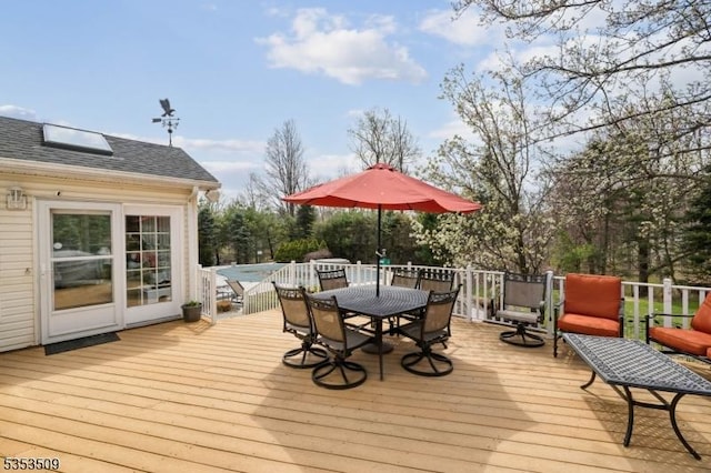 deck featuring outdoor dining area