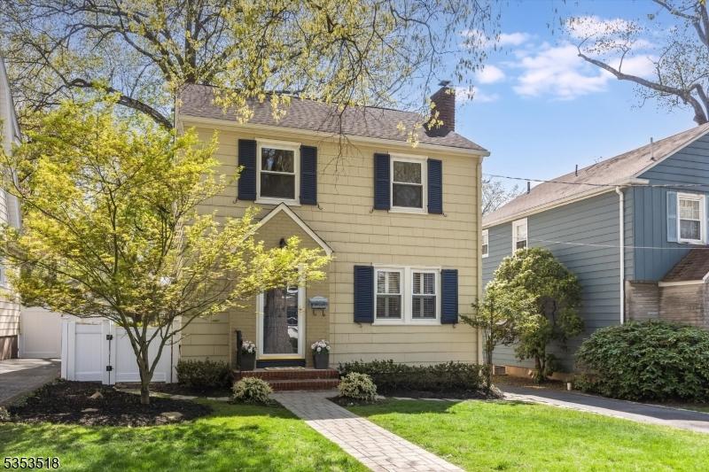 63 Newman Ave, Verona Twp, NJ 07044 - view of front of property with a chimney and a front yard