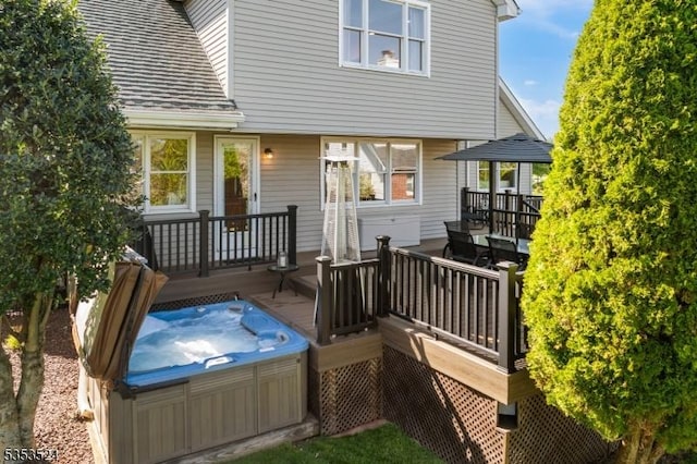 wooden terrace featuring outdoor dining area and a hot tub