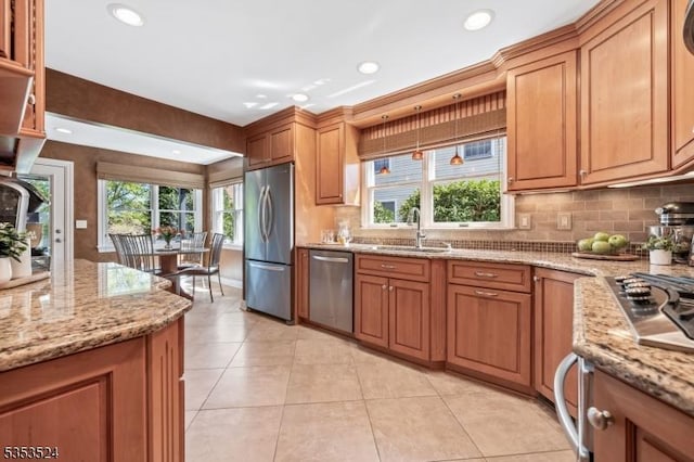 kitchen with backsplash, stainless steel appliances, light tile patterned flooring, and a sink