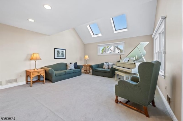 carpeted living area featuring vaulted ceiling with skylight, baseboards, recessed lighting, and visible vents