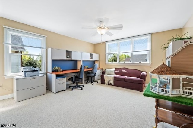 office featuring a ceiling fan and light colored carpet