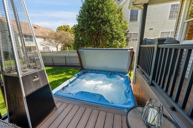 wooden deck with a hot tub and fence