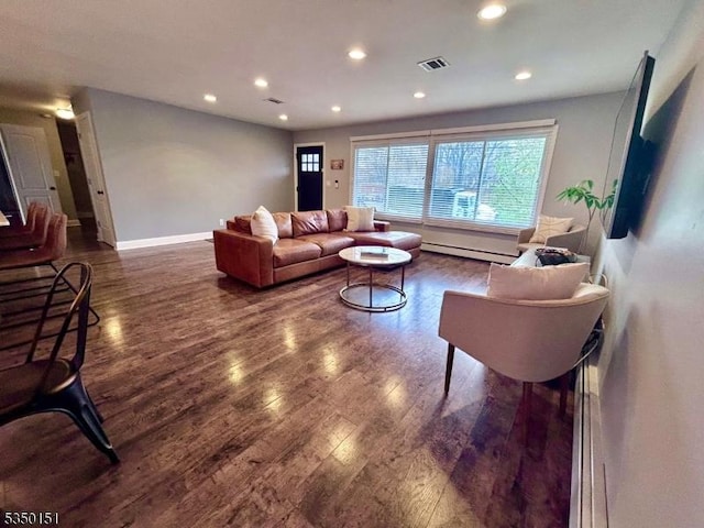 living area with recessed lighting, visible vents, and wood finished floors