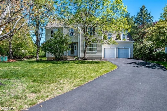 view of front of house with a front yard and aphalt driveway