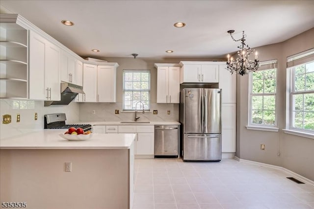kitchen featuring visible vents, open shelves, a sink, an inviting chandelier, and stainless steel appliances