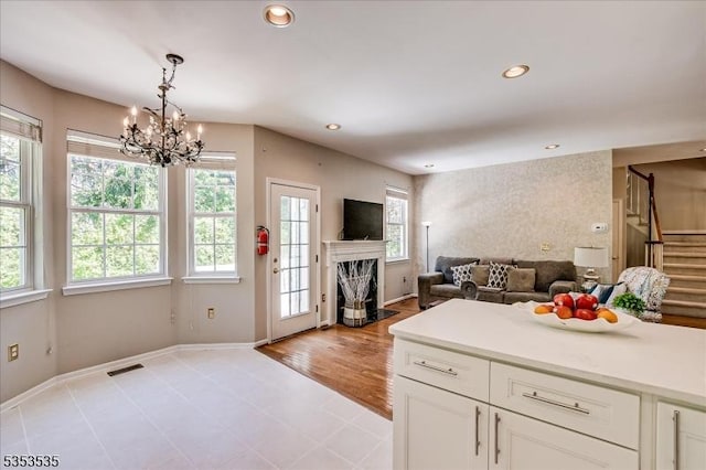 kitchen featuring visible vents, an inviting chandelier, recessed lighting, light countertops, and white cabinets