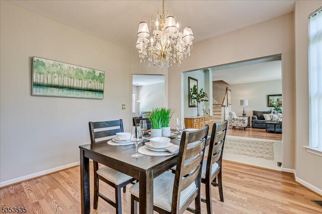 35 Hansom Rd, Bernards Twp, NJ 07920 - dining area with stairs, baseboards, an inviting chandelier, and light wood-type flooring