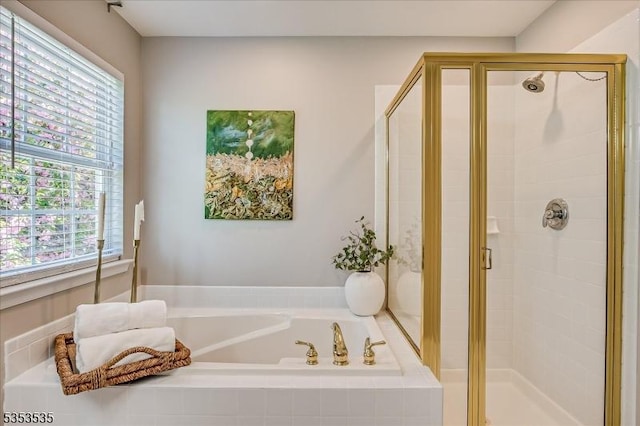 full bath featuring a stall shower, a bath, and a wealth of natural light