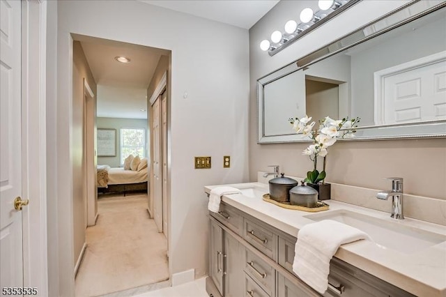 full bathroom with double vanity, a sink, connected bathroom, and recessed lighting