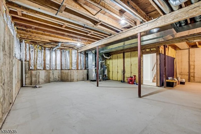 unfinished basement featuring heating unit
