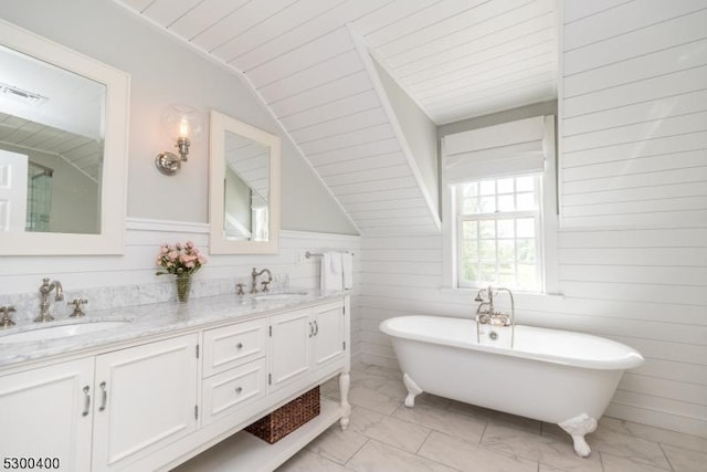 bathroom with marble finish floor, a sink, double vanity, and visible vents