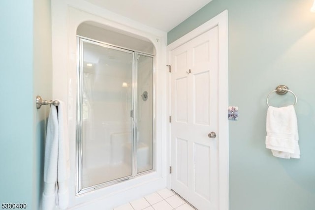 bathroom with tile patterned floors and a shower stall