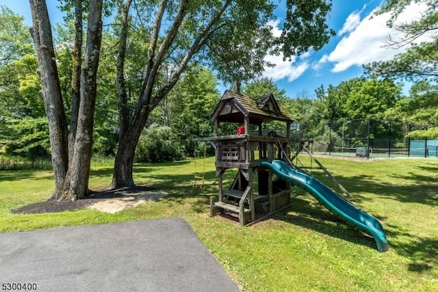 view of play area with a lawn and fence
