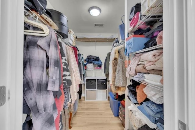spacious closet featuring visible vents and wood finished floors