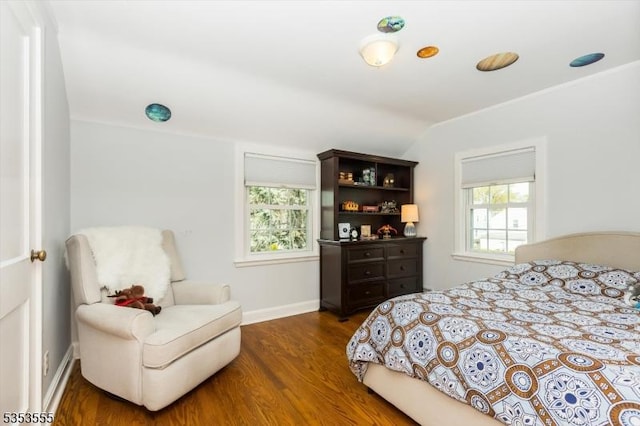 bedroom with lofted ceiling, wood finished floors, and baseboards