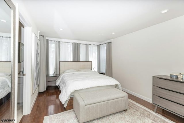 bedroom featuring baseboards, recessed lighting, and wood finished floors
