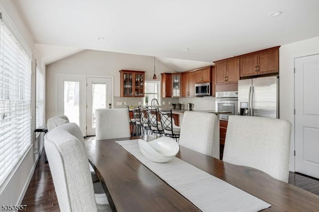 dining space featuring dark wood-style floors and lofted ceiling